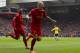 Liverpool's Martin Skrtel, centre, celebrates after scoring his first goal against Arsenal during their English Premier League soccer match at Anfield Stadium, Liverpool, England, Saturday Feb. 8, 2014. (AP Photo/Jon Super)