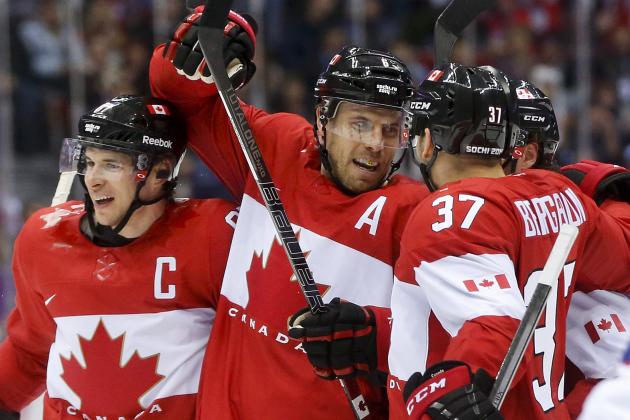 Canada defenseman Shea Weber, center, celebrates with forward Sidney Crosby, left, and forward Patrice Bergeron after scoring a goal against Norway in the second period of a men's ice hockey game at the 2014 Winter Olympics, Thursday, Feb. 13, 2014, in Sochi, Russia. (AP Photo/Julio Cortez)