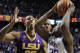 Kentucky's Julius Randle (30) looks for an opening on LSU's Jordan Mickey (25) and Jarell Martin during the second half of an NCAA college basketball game, Saturday, Feb. 22, 2014, in Lexington, Ky. Kentucky won 77-76. (AP Photo/James Crisp)