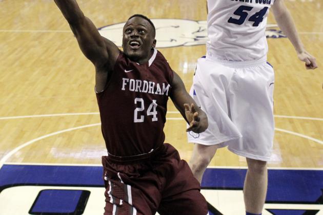Fordham's Bryan Smith (24) heads to the basket as Saint Louis' John Manning defends during the second half of an NCAA college basketball game Saturday, Jan. 18, 2014, in St. Louis. Saint Louis won 70-48. (AP Photo/Jeff Roberson)