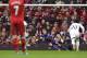 Liverpool's Simon Mignolet, centre, dives in vain as he attempts to stop a penalty by Swansea City's Wilfried Bony, centre left, during their English Premier League soccer match at Anfield Stadium, Liverpool, England, Sunday Feb. 23, 2014. (AP Photo/Jon Super)