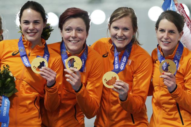 Gold medallists from team Netherlands, left to right, Marrit Leenstra, Jorien ter Mors, Lotte van Beek, and Ireen Wust hold hold their medals during the medal ceremony for the women's team pursuit at the Adler Arena Skating Center at the 2014 Winter Olympics, Saturday, Feb. 22, 2014, in Sochi, Russia. (AP Photo/Matt Dunham)
