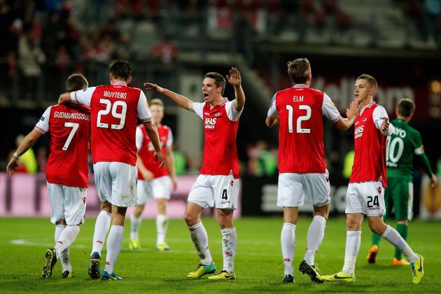 ALKMAAR, NETHERLANDS - NOVEMBER 28: Johann Berg Gudmundsson (#7) of AZ is congratulated by team mates after he shoots and scores the second goal of the ganme during the UEFA Europa League Group L match between AZ Alkmaar and Maccabi Haifa FC at the AFAS Stadium on November 28, 2013 in Alkmaar, Netherlands. (Photo by Dean Mouhtaropoulos/Getty Images)