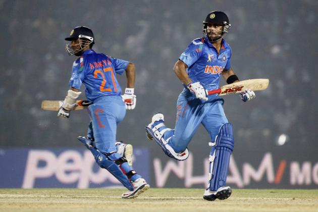 India’s Virat Kohli, right, and Ajinkya Rahane run between the wickets during the Asia Cup one-day international cricket tournament against Bangladesh in Fatullah, near Dhaka, Bangladesh, Wednesday, Feb. 26, 2014. India won by 6 wickets. (AP Photo/A.M. Ahad)
