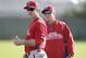 Philadelphia Phillies second baseman Chase Utley, left, looks on during spring training baseball practice Thursday, Feb. 13, 2014, in Clearwater, Fla. (AP Photo/Charlie Neibergall)