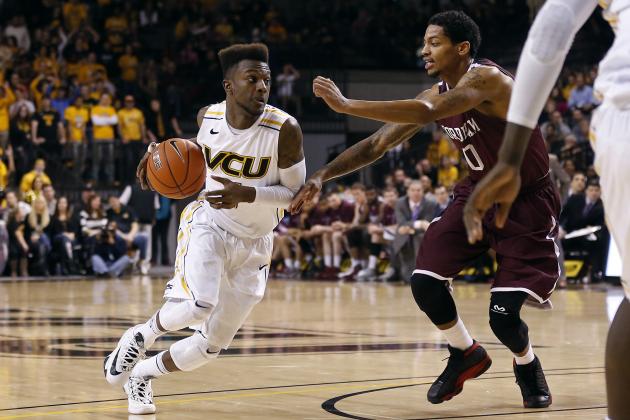 Jan 29, 2014; Richmond, VA, USA; Virginia Commonwealth Rams guard JeQuan Lewis (1) dribbles the ball as Fordham Rams guard Branden Frazier (0) defends in the second half at Stuart C. Siegel Center. The Rams won 76-60. Mandatory Credit: Geoff Burke-USA TODAY Sports
