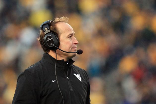 West Virginia coach Dana Holgorsen looks on from the sideline during the third quarter of their NCAA college football game against Iowa State in Morgantown, W.Va., on Saturday, Nov. 30, 2013. Iowa State won 52-44 in triple- overtime. (AP Photo/Christopher Jackson)