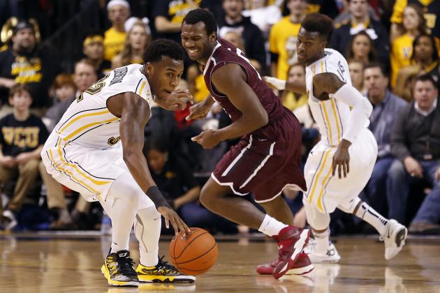 Jan 29, 2014; Richmond, VA, USA; Virginia Commonwealth Rams guard Melvin Johnson (32) steal the ball from Fordham Rams guard Jon Severe (10) in the first half at Stuart C. Siegel Center. The Rams won 76-60. Mandatory Credit: Geoff Burke-USA TODAY Sports