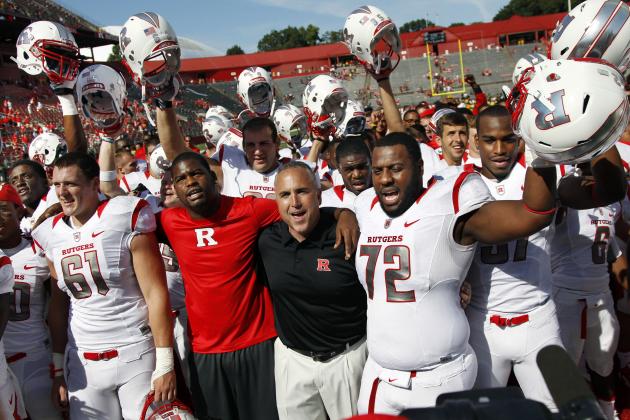 Rutgers head coach Kyle Flood, second right, joins his players singing Rutgers Alma Mater,