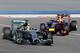 Formula One driver Daniel Ricciardo of Red Bull Racing chases Formula One driver Lewis Hamilton of Mercedes down the track during pre-season testing at the Bahrain International Circuit in Sakhir, Bahrain, on Friday, Feb. 28, 2014. (AP Photo/Hasan Jamali)