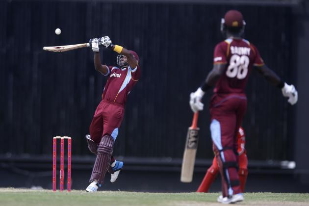 West Indies' Dwayne Bravo plays a shot for four runs of England's Chris Jordan as Darren Sammy looks on during their first one-day international cricket match at the Sir Vivian Richards Cricket Ground in St. John's, Antigua, Friday, Feb. 28, 2014. (AP Photo/Ricardo Mazalan)
