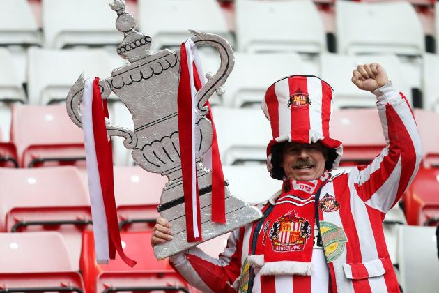Sunderland supporter George Slough holds a cardboard FA Cup at the end of their English FA Cup fifth round soccer match against Southampton at the Stadium of Light, Sunderland, England, Saturday, Feb. 15, 2014. (AP Photo/Scott Heppell)