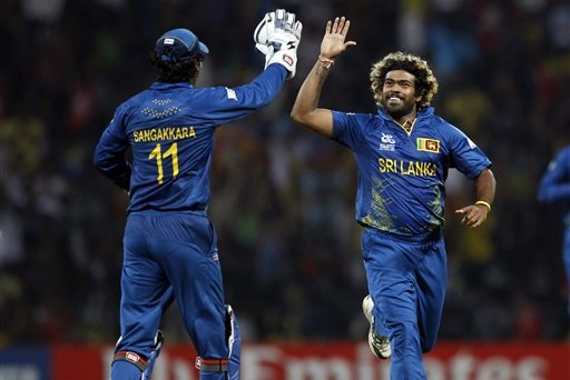 Sri Lanka's bowler Lasith Malinga, right, celebrates with teammate Kumar Sangakkara after taking the wicket of England's batsman Jos Buttler, not seen, during the ICC Twenty20 Cricket World Cup Super Eight match in Pallekele, Sri Lanka, Monday, Oct. 1, 2012. (AP Photo/Aijaz Rahi)