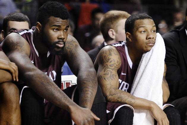 Fordham's Travion Leonard, left, and Chris Whitehead, watch play during the second half of an NCAA college basketball game against Massachusetts, Sunday, Jan. 26, 2014, in Amherst, Mass. Massachusetts won 90-52.   (AP Photo/Jessica Hill)