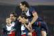 PSG's Zlatan Ibrahimovic, center, carries teammate Edinson Cavani after Ibrahimovic scored the opening goal during the Group C Champions League soccer match between Paris Saint Germain and Olympiakos FC at the Parc des Princes stadium in Paris, Wednesday, Nov.27, 2013. (AP Photo/Michel Euler)