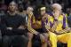 Los Angeles Lakers injured guard Kobe Bryant, left, center Jordan Hill, second from left, center Chris Kaman and guard Jordan Farmar, right, sit on the bench during the Milwaukee Bucks' 94-79 win in an NBA basketball game Tuesday, Dec. 31, 2013, in Los Angeles. (AP Photo/Alex Gallardo)