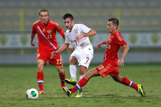 DUBAI, UNITED ARAB EMIRATES - NOVEMBER 15:  Zoran Tosic (C) of Serbia  fight for the ball with Alexey Kozlov (L) of Russia and Victor Fayzulin (R) of Russia during the International Football match between Serbia and Russia at the Zabeel Stauduim on November 15, 2013 in Dubai, United Arab Emirates.  (Photo by Francois Nel/Getty Images)