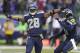 In this Nov. 17, 2013, photo, Seattle Seahawks' Byron Maxwell, right, smiles as he joins Walter Thurmond after Thurmond's interception and touchdown against the Minnesota Vikings during an NFL football game in Seattle. Thurmond is returning from his four-game suspension just in time to join the Seahawks for the postseason. But Thurmond has lost the starting spot he had before the suspension arrived. Thurmond is expected to be activated to Seattle's roster before Sunday's game against St. Louis. (AP Photo/Ted S. Warren)