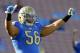 UCLA guard Xavier Su'a-Filo (56) warms up on the field prior to their NCCA college football game against Colorado Saturday, Nov. 2, 2013, in Pasadena, Calif. (AP Photo/Alex Gallardo)