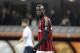 AC Milan forward Mario Balotelli walks on the field during the Serie A soccer match between AC Milan and Bologna at the San Siro stadium in Milan, Italy, Friday, Feb. 14, 2014. (AP Photo/Antonio Calanni)