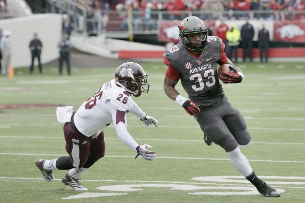 Mississippi State defensive back Kendrick Market (26) dives for Arkansas safety Korliss Marshall (33) in the first half of an NCAA college football game in Little Rock, Ark., Saturday, Nov. 23, 2013. (AP Photo/Danny Johnston)