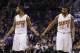 Phoenix Suns' Marcus Morris (15) and Markieff Morris (11) shake hands during the first half of an NBA basketball game against the Miami Heat Tuesday, Feb. 11, 2014, in Phoenix. The Heat defeated the Suns 103-97. (AP Photo/Ross D. Franklin)