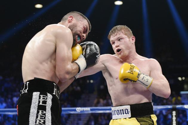 LAS VEGAS, NV - MARCH 8: Canelo Alvarez throws a punch against Alfredo Angulo (L) during the non-title, 12-round super welterweight bout at the MGM Grand Garden March 8, 2014, in Las Vegas, Nevada. Alvarez won by technical knock out after the referee stopped the fight in the 10th round. (Photo by Kevork Djansezian/Getty Images)