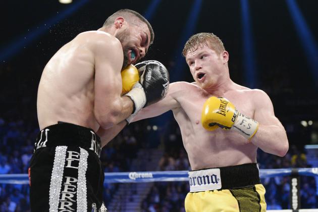 LAS VEGAS, NV - MARCH 8: Canelo Alvarez throws a punch against Alfredo Angulo (L) during the non-title, 12-round super welterweight bout at the MGM Grand Garden March 8, 2014, in Las Vegas, Nevada. Alvarez won by technical knock out after the referee stopped the fight in the 10th round. (Photo by Kevork Djansezian/Getty Images)