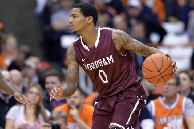 Nov 12, 2013; Syracuse, NY, USA; Fordham Rams guard Branden Frazier (0) moves the ball with Syracuse Orange forward C.J. Fair (5) defending during the second half of a game at the  Carrier Dome. Syracuse won the game  89-74. Mandatory Credit: Mark Konezny-USA TODAY Sports
