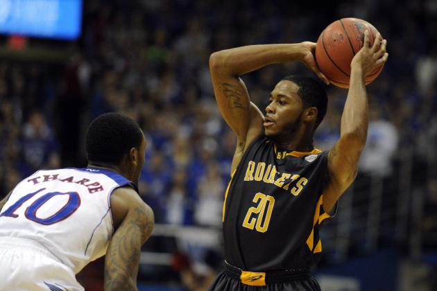 Dec 30, 2013; Lawrence, KS, USA; Toledo Rockets guard Julius Brown (20) passes against Kansas Jayhawks guard Naadir Tharpe (10) in the second half at Allen Fieldhouse. Kansas won 93-83. Mandatory Credit: John Rieger-USA TODAY Sports