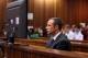 Oscar Pistorius, foreground, sits in the dock during his trial at the high court in Pretoria, South Africa, Friday, March 7, 2014. Pistorius is charged with murder for the shooting death of his girlfriend, Steenkamp, on Valentines Day in 2013. (AP Photo/Themba Hadebe, Pool)