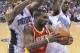 Houston Rockets' Jordan Hamilton (5) grabs a rebound in front of Orlando Magic's Kyle O'Quinn, left, and Doron Lamb during the first half of an NBA basketball game in Orlando, Fla., Wednesday, March 5, 2014. (AP Photo/John Raoux)