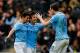 HULL, ENGLAND - MARCH 15: Edin Dzeko (R) of Manchester City celebrates his goal with team mates Jesus Navas (L) and David Silva during the Barclays Premier League match between Hull City and Manchester City at the KC Stadium on March 15, 2014 in Hull, England. (Photo by Paul Thomas/Getty Images)