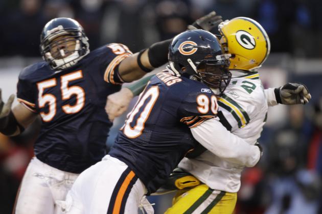 Chicago Bears defensive end Julius Peppers (90) hits Green Bay Packers quarterback Aaron Rodgers (12) as he passes the ball during the second half of the NFC Championship NFL football game Sunday, Jan. 23, 2011, in Chicago. Peppers was called for roughing the passer. (AP Photo/David J. Phillip)