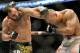 Johny Hendricks, left, and Robbie Lawler exchange punches during a UFC 171 mixed martial arts welterweight title bout, Saturday, March 15, 2014, in Dallas. Hendricks won by decision. (AP Photo/Matt Strasen)