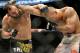Johny Hendricks, left, and Robbie Lawler exchange punches during a UFC 171 mixed martial arts welterweight title bout, Saturday, March 15, 2014, in Dallas. Hendricks won by decision. (AP Photo/Matt Strasen)