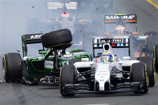 Caterham driver Kamui Kobayashi of Japan, left, collides with Williams driver Felipe Massa of Brazil at the start of the Australian Formula One Grand Prix at Albert Park in Melbourne, Australia, Sunday, March 16, 2014. Massa and Kobayashi walked away uninjured from the accident. (AP Photo/Ross Land)