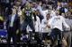 Players on the Michigan State bench react in the second half of an NCAA college basketball game against Michigan in the championship of the Big Ten Conference tournament on Sunday, March 16, 2014, in Indianapolis. (AP Photo/Michael Conroy)