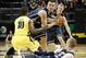 As Oregon's Johnathan Loyd (10), left, defends, BYU's Kyle Collinsworth, center, scoops up a pass from BYU's Nate Austin, foreground, as BYU's Tyler Haws moves in at right during the first half in an NCAA college basketball game in Eugene, Saturday, Dec. 21, 2013. (AP Photo/Chris Pietsch)