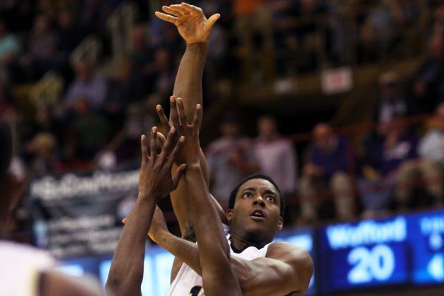 Wofford's Aerris Smith (top) shoots over Western Carolina's Tawaski King (middle) during the first half of the NCAA college basketball championship game of the Southern Conference tournament in Asheville, N.C., Monday, March 10, 2014. (AP Photo/Adam Jennings)