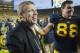 Michigan Athletic Director David Brandon, left, gives a hug to defensive end Craig Roh (88) as they celebrate after an NCAA college football game against Michigan State, Saturday, Oct. 20, 2012, in Ann Arbor, Mich. Michigan won 12-10. (AP Photo/Tony Ding)