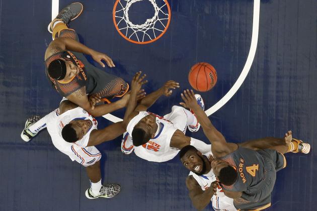 Tennessee guard Armani Moore (4) shoots against Florida center Patric Young (4) during the first half of an NCAA college basketball game in the semifinal round of the Southeastern Conference men's tournament, Saturday, March 15, 2014, in Atlanta. (AP Photo/John Bazemore)