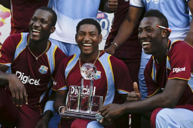West Indies' Darren Sammy, left,  Krishmar Santokie, center, and Andre Russell, pose with the trophy after beating England 2-1, in the series of three T20 International cricket matches at the Kensington Oval in Bridgetown, Barbados, Thursday, March 13, 2014. (AP Photo/Ricardo Mazalan)