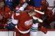 Detroit Red Wings right wing Tomas Jurco (26) checks Vancouver Canucks defenseman Alexander Edler of Sweden into the Red Wings bench during the first period of an NHL hockey game in Detroit, Monday, Feb. 3, 2014. (AP Photo/Carlos Osorio)