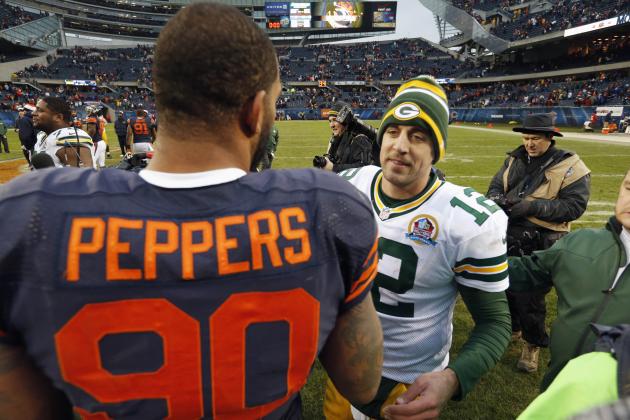 Green Bay Packers quarterback Aaron Rodgers (12) and Chicago Bears defensive end Julius Peppers (90) meet after their NFL football game in Chicago, Sunday, Dec. 16, 2012. The Packers won 21-13 to clinch the NFC North division title. (AP Photo/Charles Rex Arbogast)