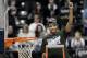 Michigan State guard Gary Harris holds up a piece of the net after his team defeated Michigan 69-55 in an NCAA college basketball game in the championship of the Big Ten Conference tournament on Sunday, March 16, 2014, in Indianapolis. (AP Photo/AJ Mast)