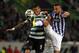 Porto's Nabil Ghilas, from Algeria, tussles for the ball with Sporting's Marcos Rojo, left, from Argentina, during the Portuguese league soccer match between Sporting and Porto at Sporting's Alvalade stadium, in Lisbon, Sunday, March 16, 2014. Sporting won 1-0. (AP Photo/Francisco Seco)