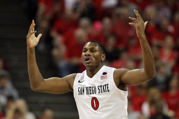 San Diego State's Skylar Spencer raises his hands to the crowd after dunking during the first half of an NCAA college basketball game against New Mexico for the Mountain West Conference tournament championship on Saturday, March 15, 2014, in Las Vegas. (AP Photo/Isaac Brekken)