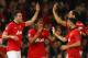 MANCHESTER, ENGLAND - MARCH 19: Robin van Persie of Manchester United celebrates scoring the second goal with his team-mates during the UEFA Champions League Round of 16 second round match between Manchester United and Olympiacos FC at Old Trafford on March 19, 2014 in Manchester, England. (Photo by Laurence Griffiths/Getty Images)
