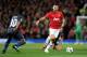 Olympiakos' Leandro Salino, left, competes for the ball with Manchester United's Ryan Giggs during their Champions League last 16 second leg soccer match at Old Trafford Stadium, Manchester, England, Wednesday, March 19, 2014. (AP Photo/Jon Super)